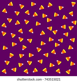 Candy corn on purple background, Halloween trick or treat