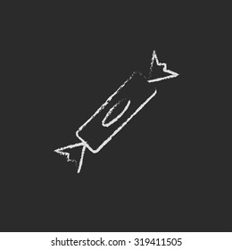 Candy hand drawn in chalk on a blackboard vector white icon isolated on a black background.