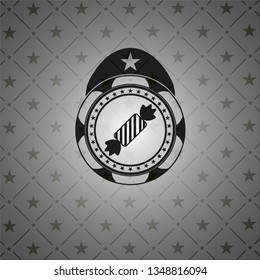candy icon inside black emblem