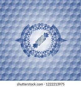 candy icon inside blue emblem or badge with abstract geometric polygonal pattern background.