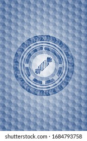 icono de caramelo dentro del emblema azul con un patrón geométrico.