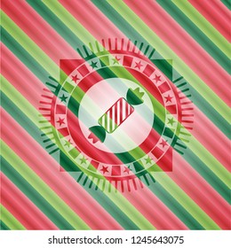 candy icon inside christmas badge.