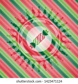 candy icon inside christmas emblem.
