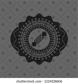 candy icon inside dark emblem