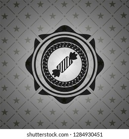 candy icon inside dark emblem. Retro