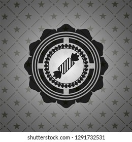 candy icon inside dark emblem