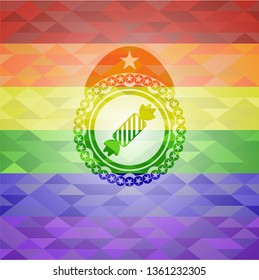 candy icon inside emblem on mosaic background with the colors of the LGBT flag