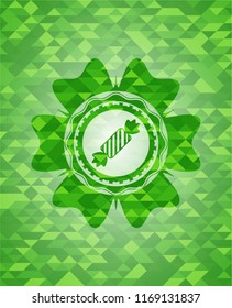 candy icon inside green emblem with mosaic ecological style background