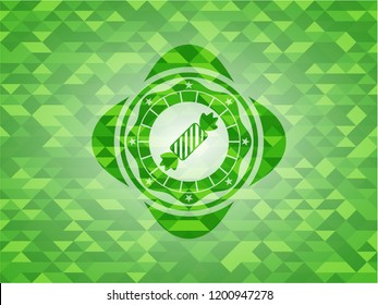 candy icon inside green emblem with triangle mosaic background