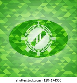candy icon inside green emblem. Mosaic background