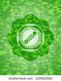 candy icon inside green emblem. Mosaic background