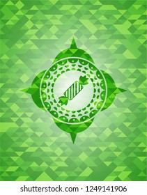 candy icon inside green emblem with mosaic background