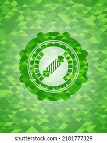 icono de caramelo dentro del emblema del mosaico verde. 