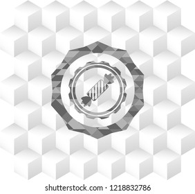 candy icon inside grey emblem with geometric cube white background