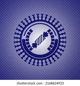 candy icon inside jean or denim emblem or badge background. 