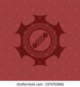 candy icon inside red emblem