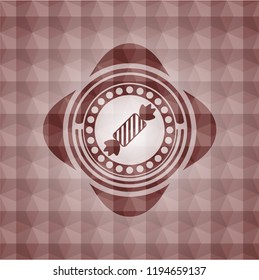 candy icon inside red seamless emblem with geometric pattern background.