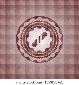 candy icon inside red seamless badge with geometric pattern.