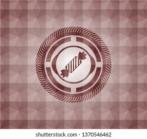 candy icon inside red seamless badge with geometric pattern.