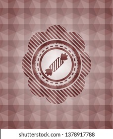 candy icon inside red seamless emblem or badge with abstract geometric pattern background.
