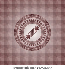 candy icon inside red seamless emblem with geometric pattern background.