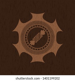 candy icon inside retro style wood emblem