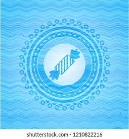 candy icon inside water representation style badge.