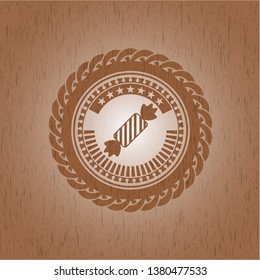 candy icon inside wood badge or emblem