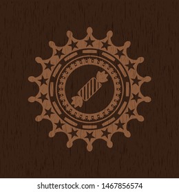 candy icon inside wooden emblem. Vintage.