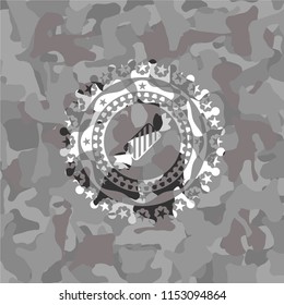 candy icon on grey camouflaged pattern