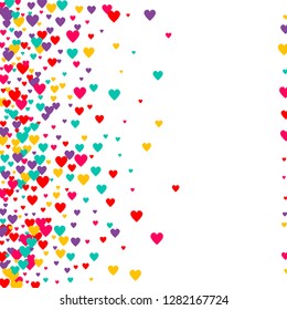 Candy of red, yellow, blue and purple hearts on a white background. Flying confetti from hearts. Valentine's day card.