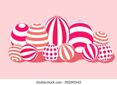 Candy and sweet eggs with bright colorful stripes on a pink background, for celebration, party and spring time easter feast.