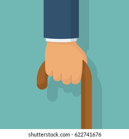 Cane in hand, isolated on white background. Old man's hand hording an old wood walking stick for support. Vector illustration flat design.