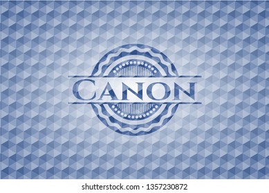 Canon blue emblem or badge with geometric pattern background.