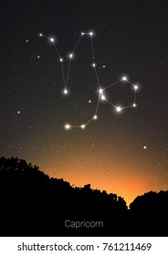 Capricorn zodiac constellations sign with forest landscape silhouette on beautiful starry sky with galaxy and space behind. Capricorn horoscope symbol constellation on deep cosmos background.