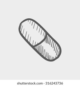 Capsule pill sketch icon for web, mobile and infographics. Hand drawn vector dark grey icon isolated on light grey background.