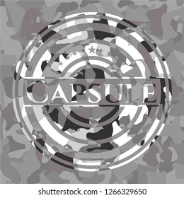 Capsule written on a grey camouflage texture
