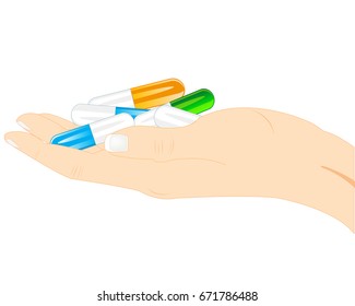 Capsules of the tablets on palm of the person on white background
