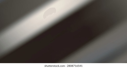 A captivating interplay of light and shadow creating an abstract pattern on a textured surface, evoking a sense of depth and mystery.
