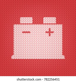 Car battery sign. Vector. Knitted white icon on a red knitted background.