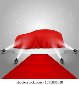 Car covered with luxury red fabric on white round podium with red carpet illuminated by floor spotlights, vector realistic illustration. New car model presentation, auto show.