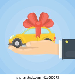 Car gift on hand. Yellow car with red ribbon.