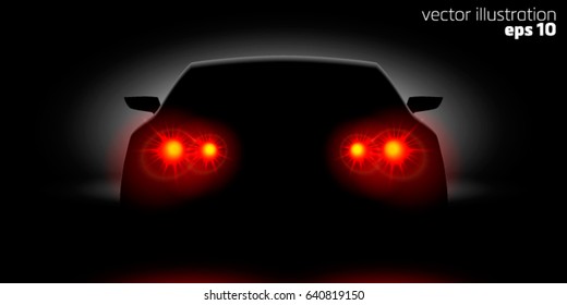 Car headlights shining in the dark back view