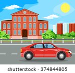 The car rides on the highway. The building and the green trees.