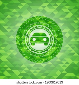 car seen from front icon inside realistic green emblem. Mosaic background