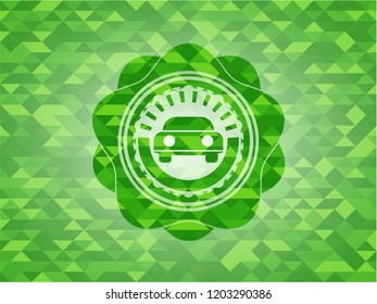 car seen from front icon inside green emblem. Mosaic background