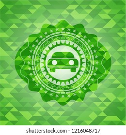 car seen from front icon inside realistic green emblem. Mosaic background
