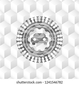 car seen from front icon inside grey badge with geometric cube white background