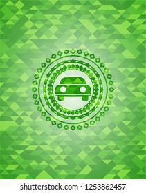 car seen from front icon inside realistic green emblem. Mosaic background
