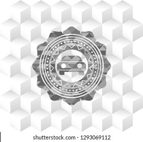 car seen from front icon inside grey emblem with geometric cube white background